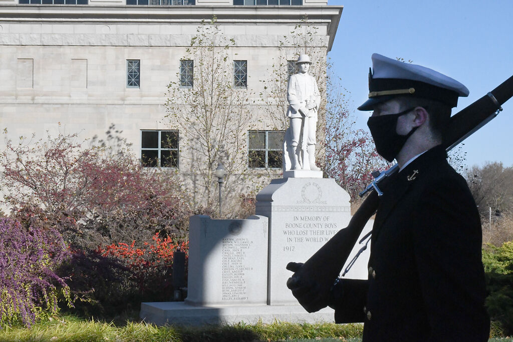 Cadet Josh Caszatt walks through the shadows of the courthouse columns on Wednesday at the Veterans Memorial.